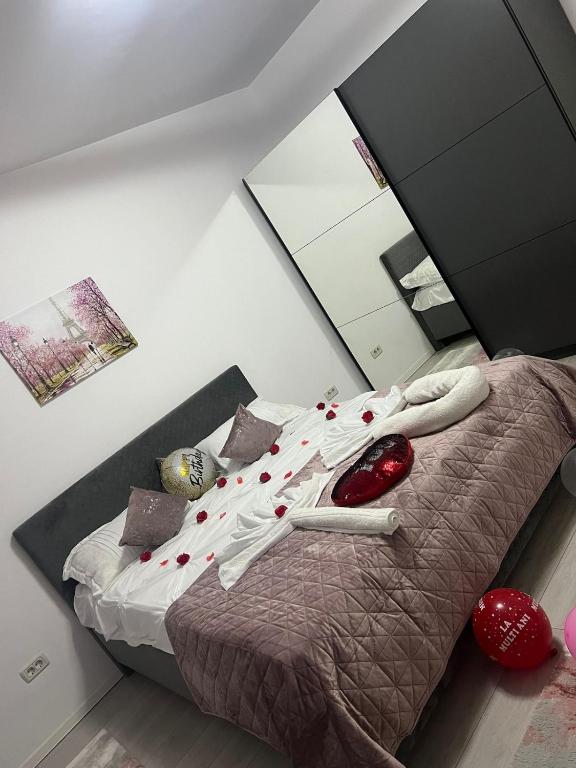 a bedroom with a bed with shoes on it at Apartament sector 5 Sara in Bucharest