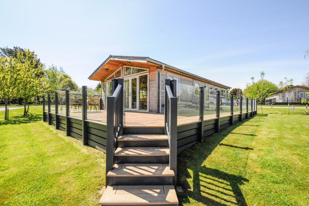 a tiny house with a staircase leading up to it at 17 Meadow Retreat in Liskeard