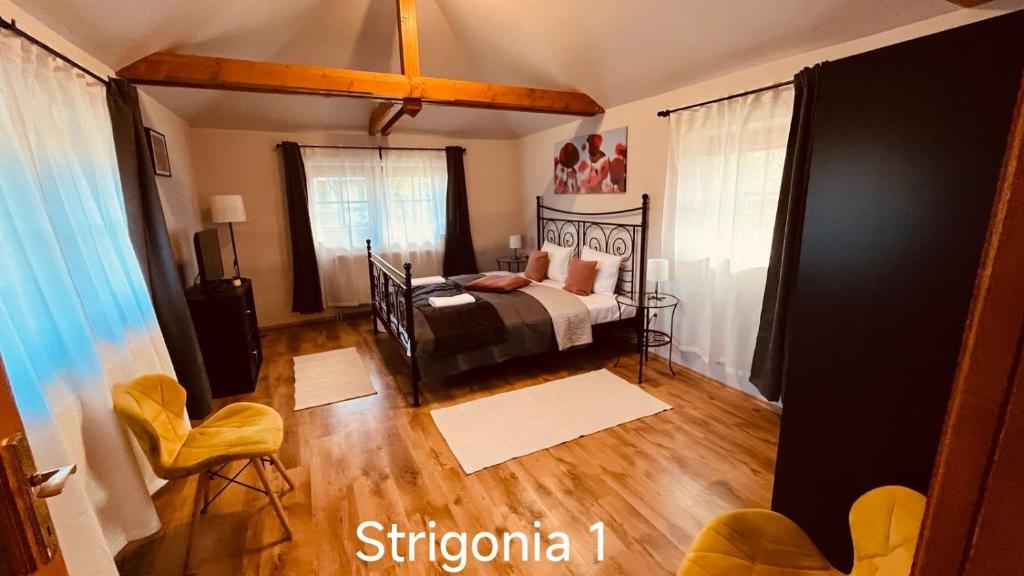 A bed or beds in a room at Strigonia Apartman