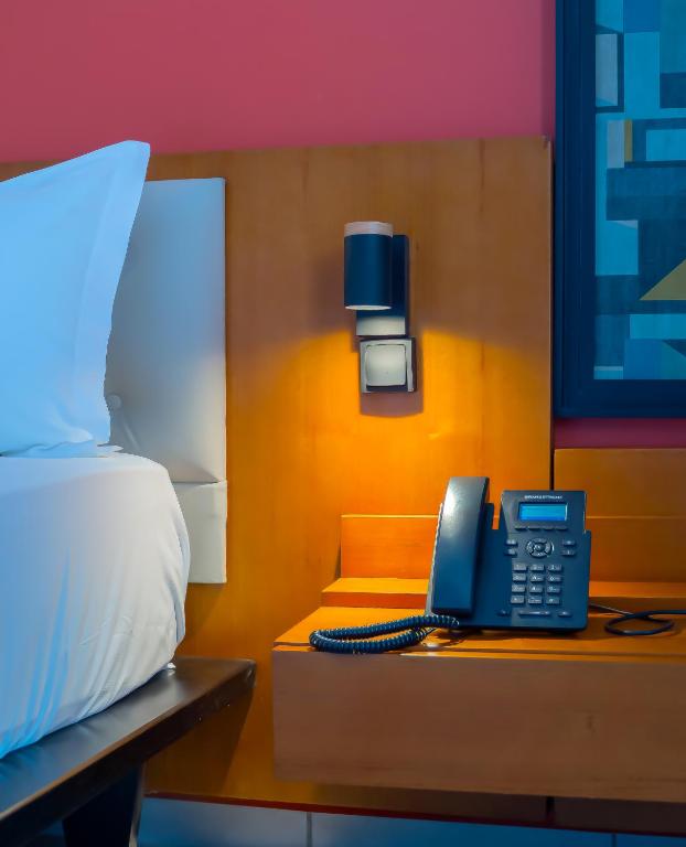 Postel nebo postele na pokoji v ubytování MANOU HOTEL
