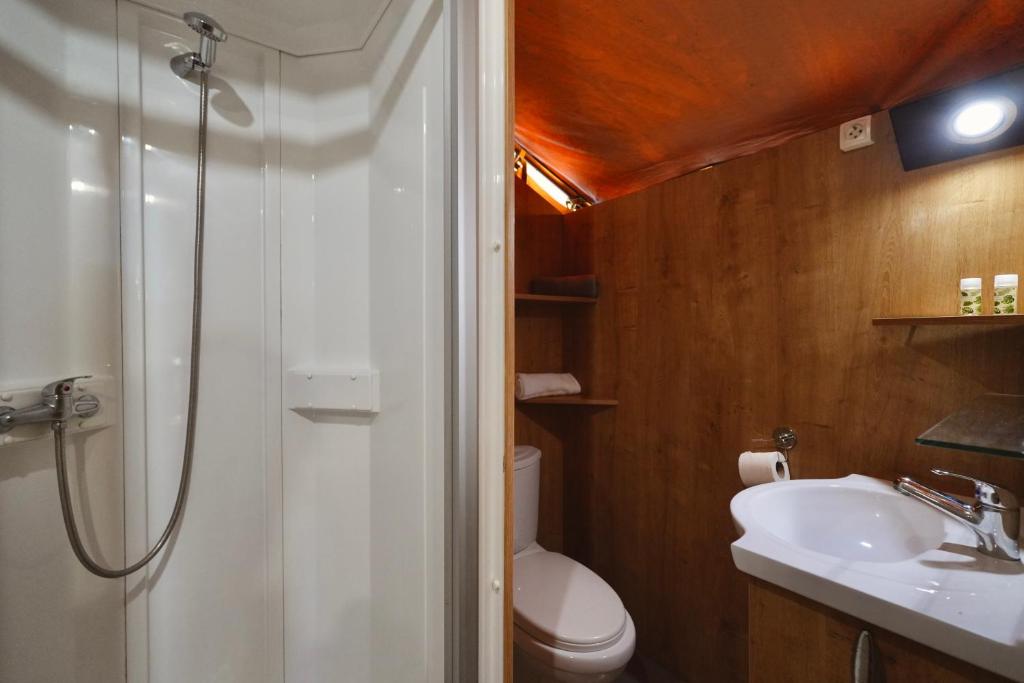 a bathroom with a shower and a toilet and a sink at Camping 3 Estrellas in Gavà