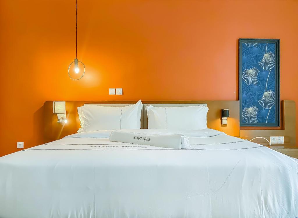 Postel nebo postele na pokoji v ubytování MANOU HOTEL