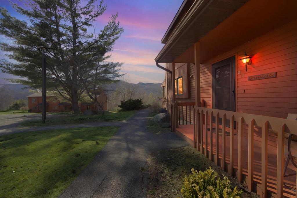 a house with a light on the side of it at Rumor 39O - Upgraded Townhome with Woodsy Views in North Creek
