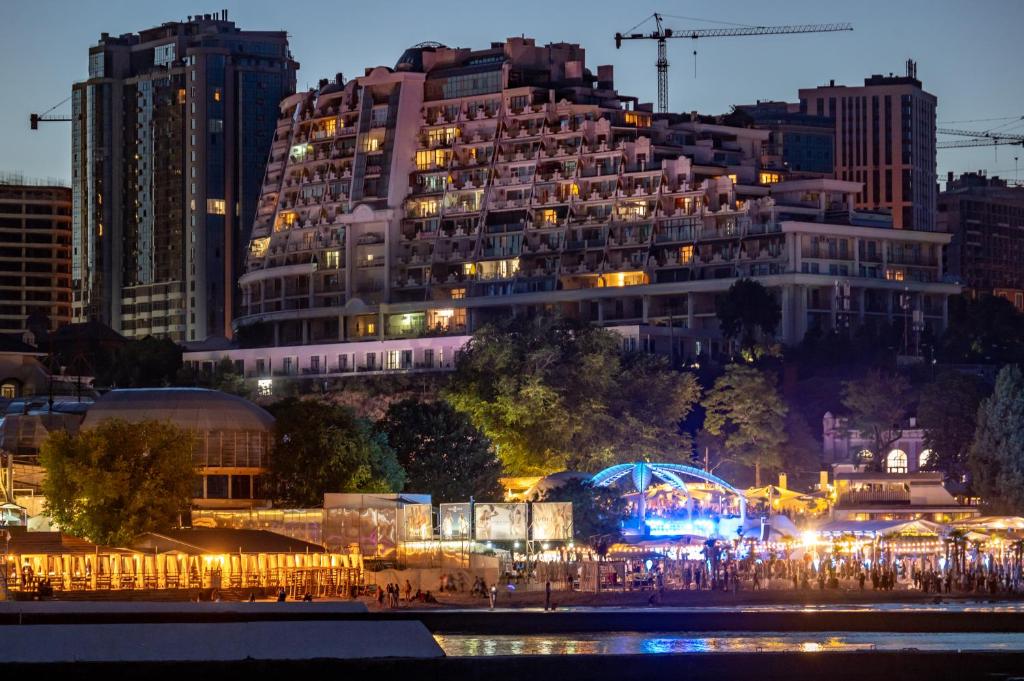 a large building with lights in front of it at Arcadia City Apartments in Odesa