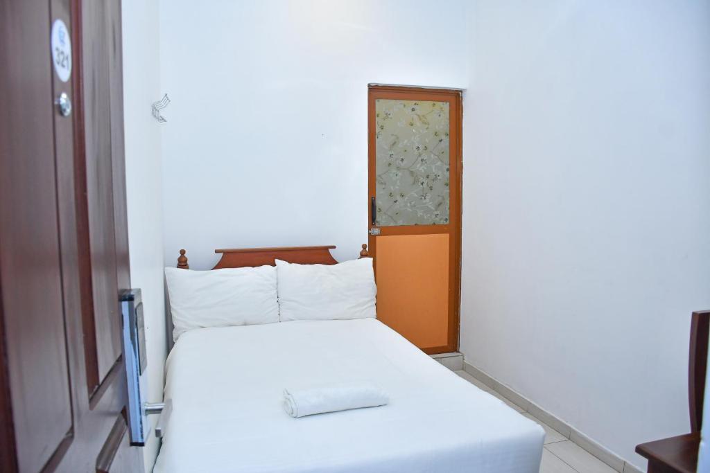 Postel nebo postele na pokoji v ubytování Ez Stay Guesthouse