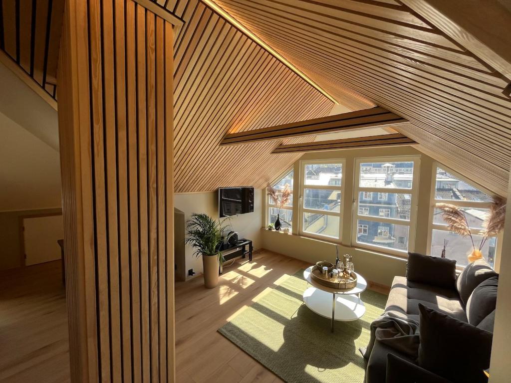 a living room with a couch and a table at Modern Apartment Vaskerelven 12 in Bergen