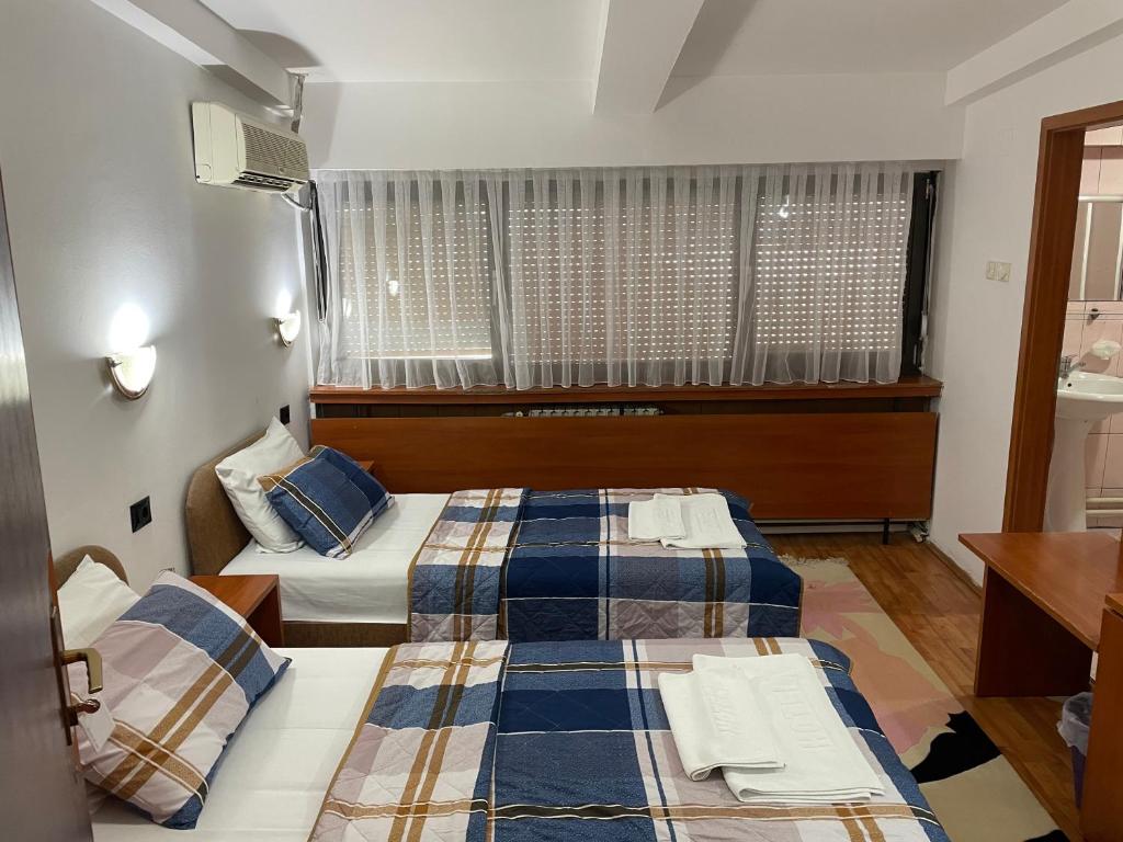 Postel nebo postele na pokoji v ubytování Hotel Square