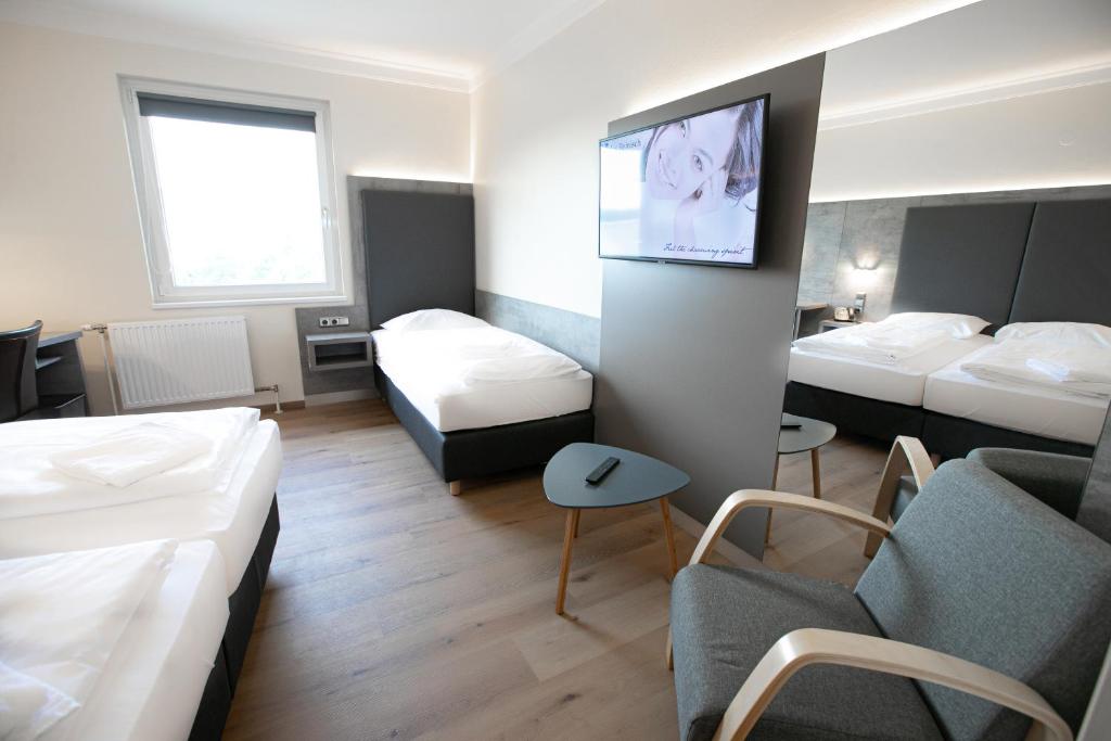 Posteľ alebo postele v izbe v ubytovaní Das Reinisch Just Rooms