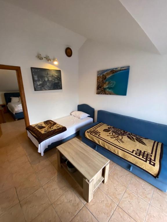 a room with two beds and a table at Casa del Mare in Ulcinj