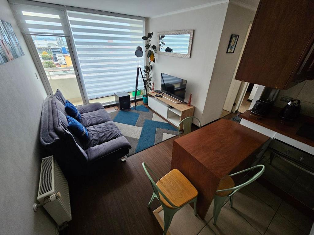 a living room with a couch and a table at Departamentos Concepcion Centro in Concepción