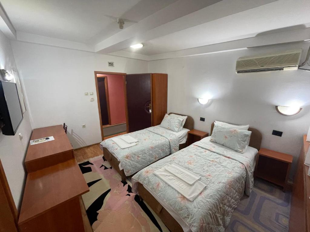 Postel nebo postele na pokoji v ubytování Hotel Square