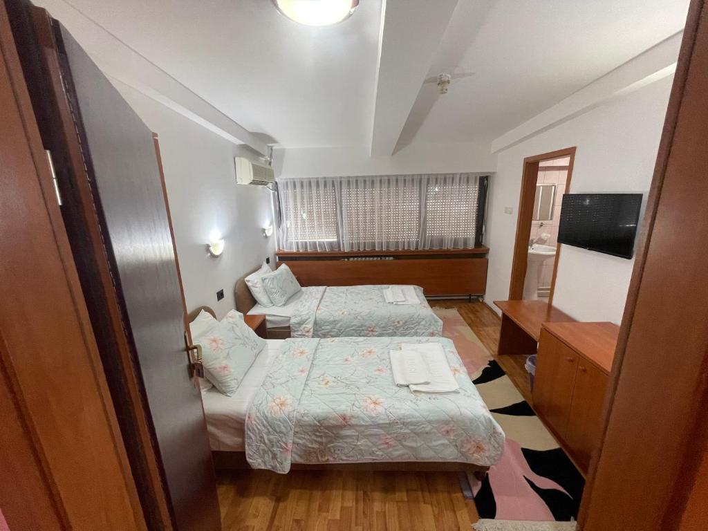 Postel nebo postele na pokoji v ubytování Hotel Square