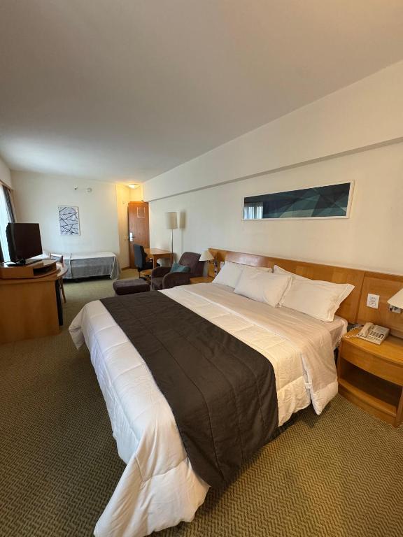 a bedroom with a large bed in a hotel room at Hotel & Residência Alphaville in Barueri