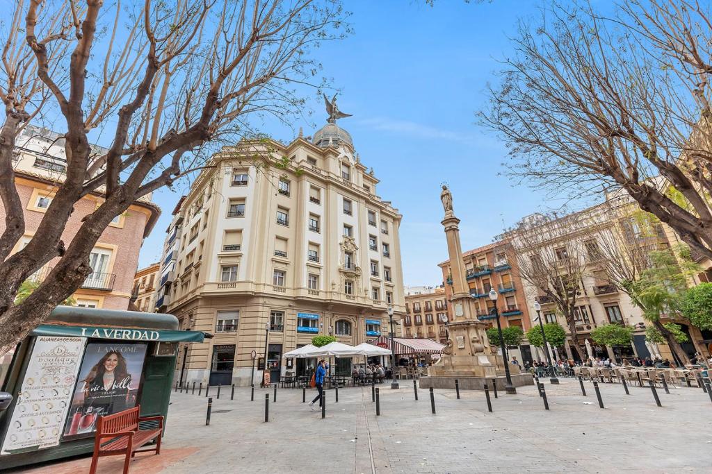 een gebouw met een standbeeld in het midden van een straat bij Luxury and emblematic apartment in Murcia