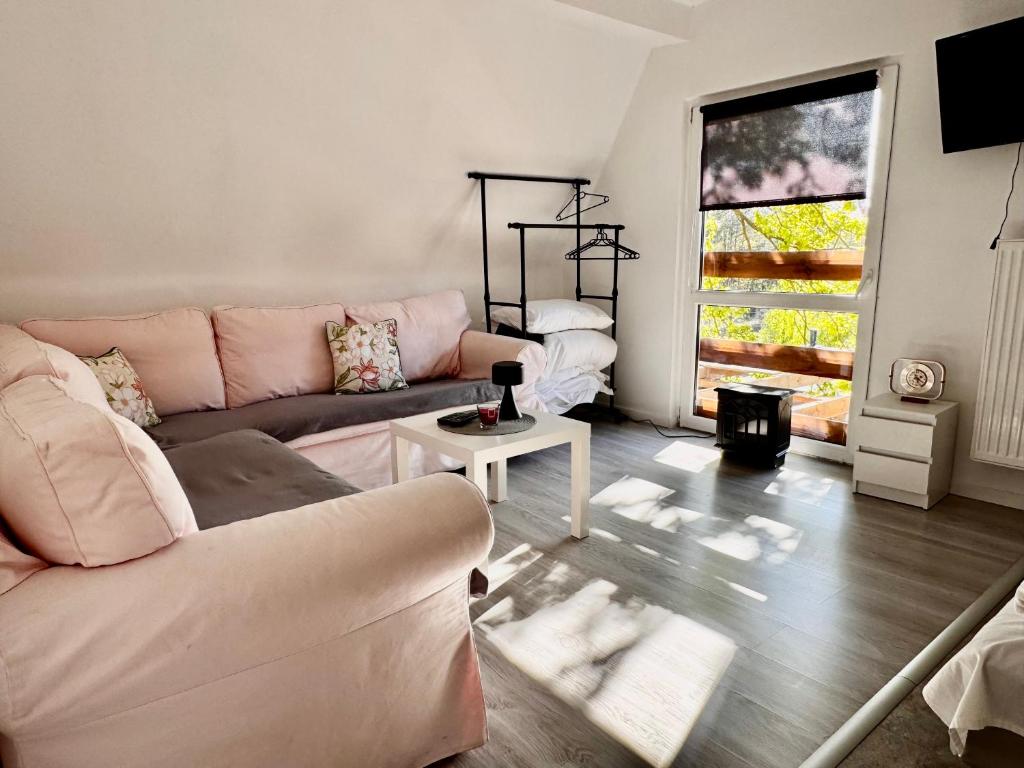 a living room with a couch and a table at Familly House in Międzyzdroje