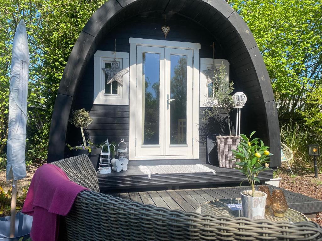 a gazebo with a door and a table at Ecolodge Almere with private outdoor terrace & beach in Almere