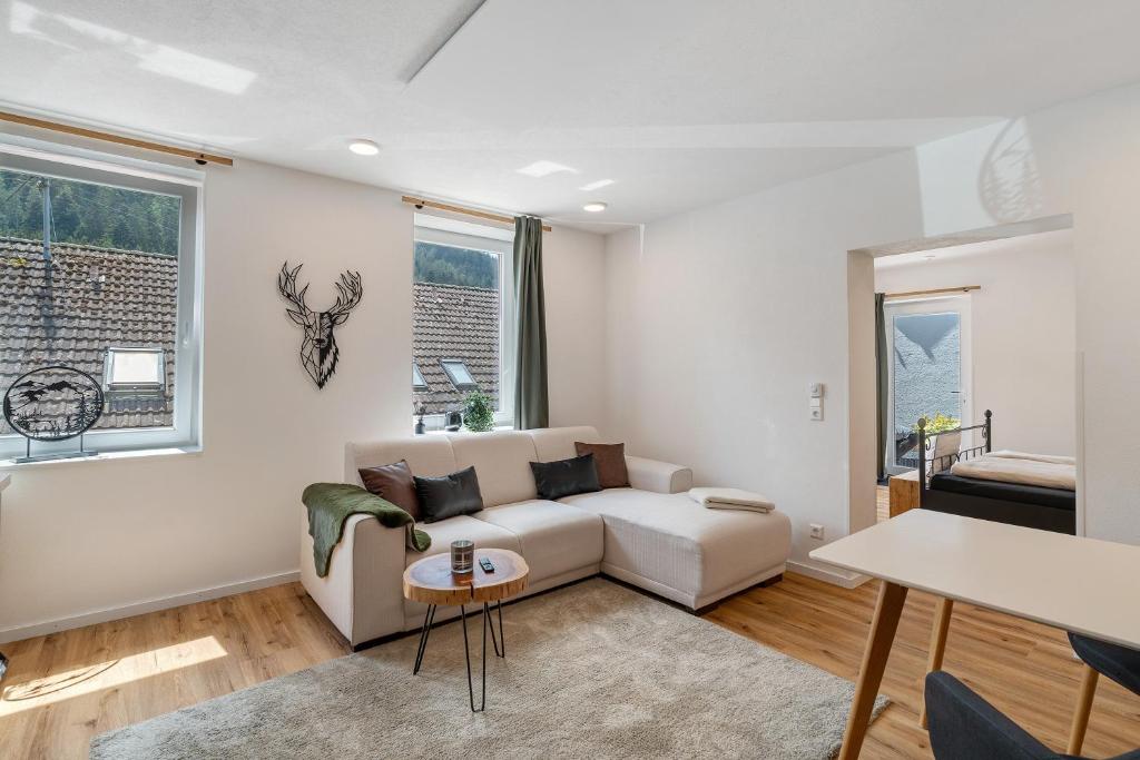 a living room with a couch and a table at Urlaub Schwarzwaldliebe in Bad Teinach-Zavelstein