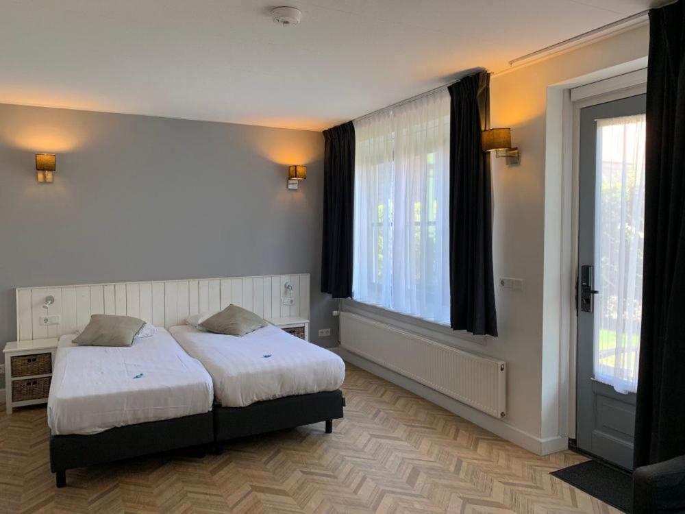 Postel nebo postele na pokoji v ubytování Hotel In den Brouwery