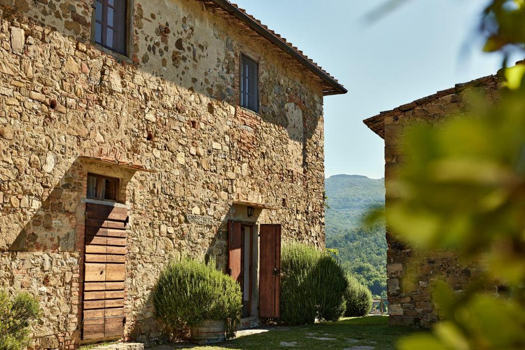 an old stone building with a door in the side of it at Agriturismo Il Pozzo in Greve in Chianti