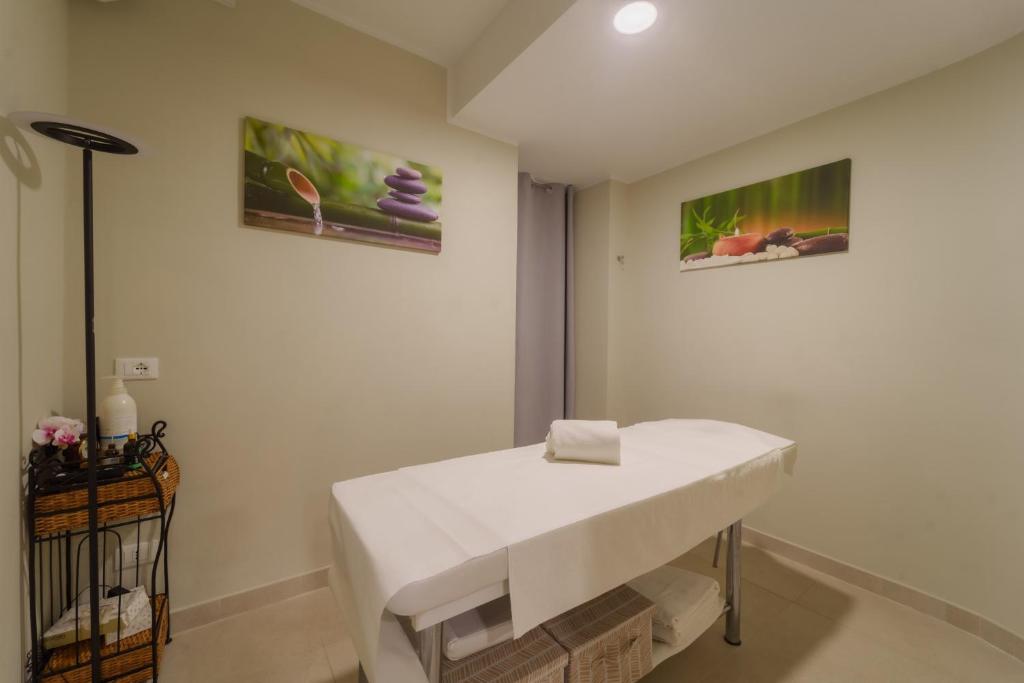 フェトヴァイアにあるHotel Galli - Wellness & Spaの壁に2枚の絵が飾られた部屋の白いシンク