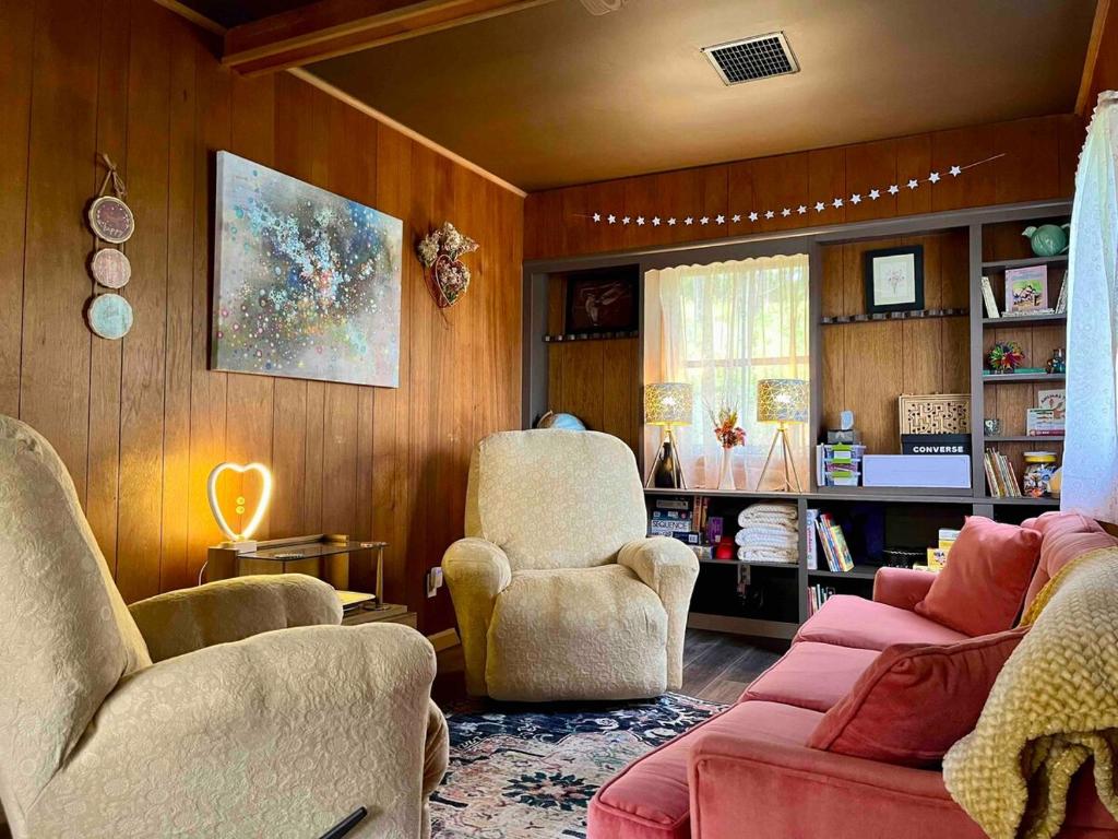 a living room with two chairs and a couch at Cassio's Cottage in Coudersport