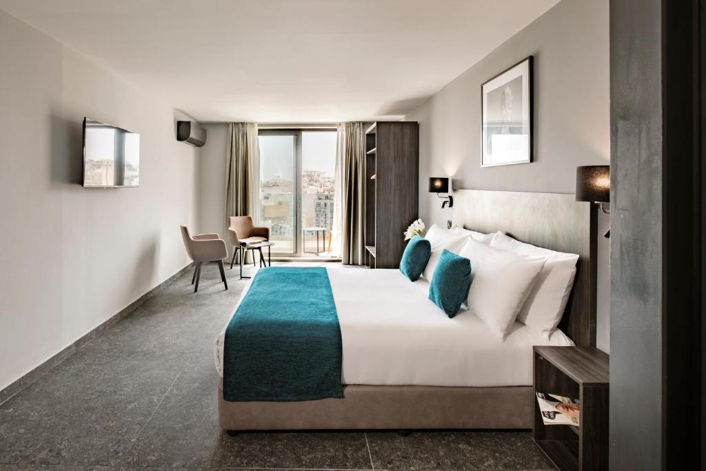 Postel nebo postele na pokoji v ubytování Spinola Hotel