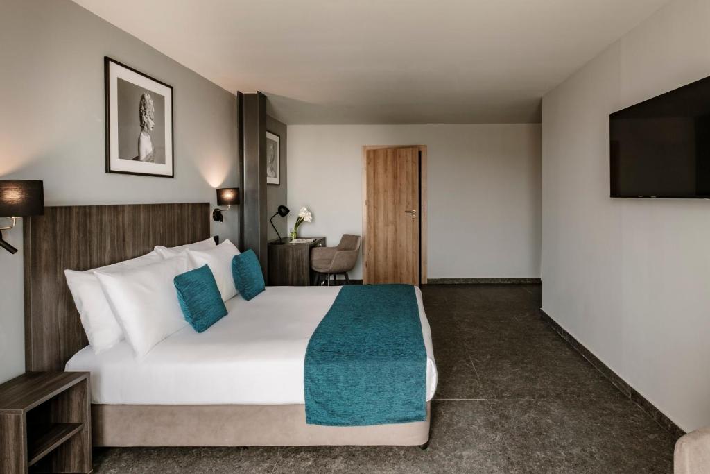 Postel nebo postele na pokoji v ubytování Spinola Hotel