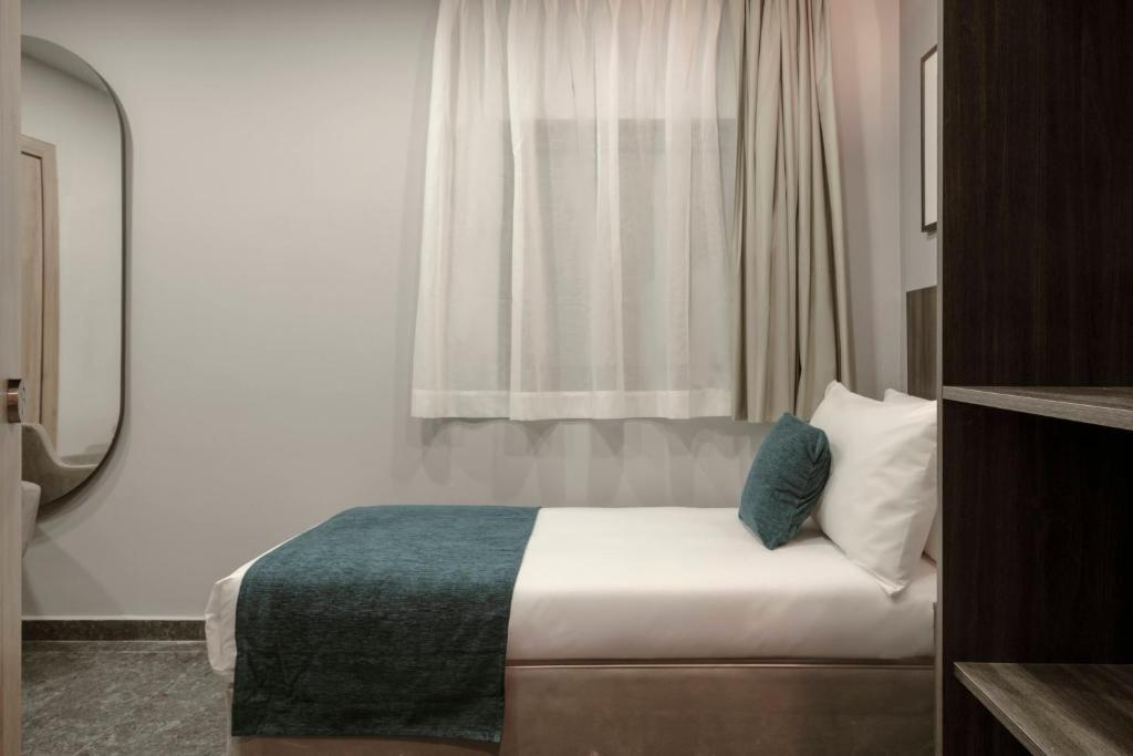 Postel nebo postele na pokoji v ubytování Spinola Hotel
