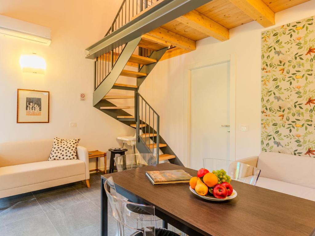 a living room with a table with a bowl of fruit at Apartment Camping Turisport-2 by Interhome in Dervio