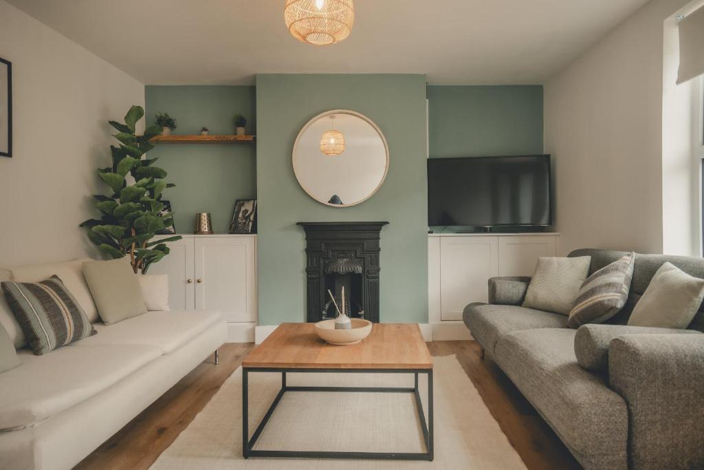 a living room with a couch and a table at Charming 3 Bedroom Home with Garden in Banbury in Banbury