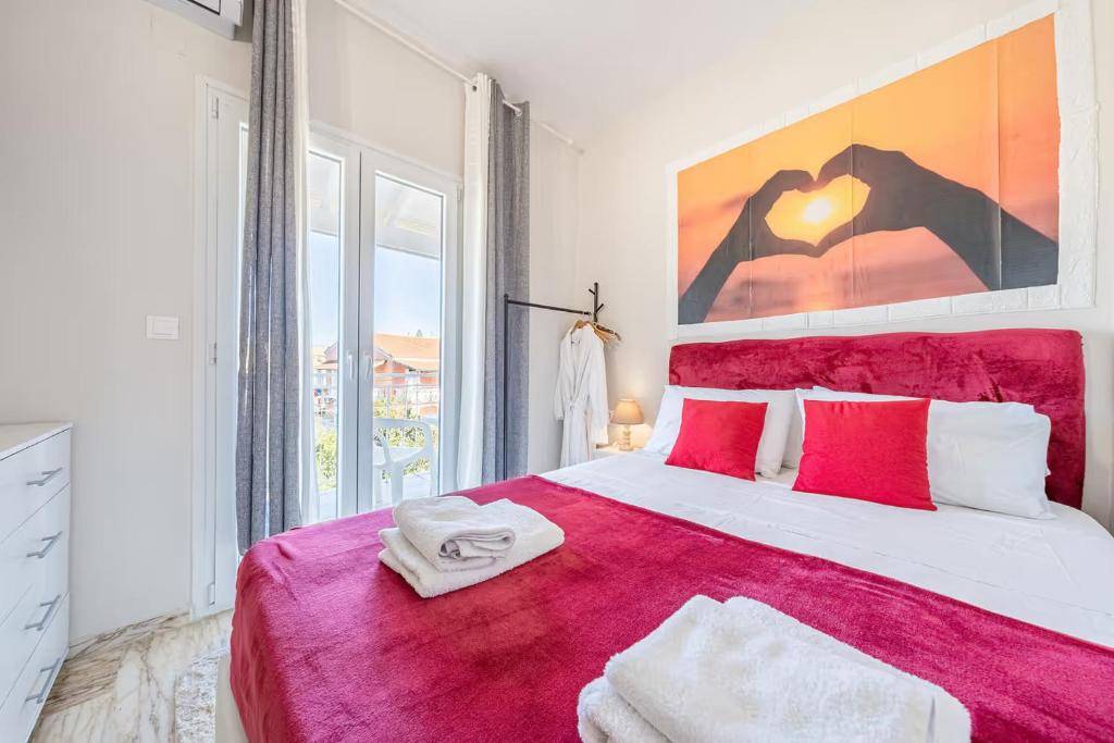 a bedroom with a large bed with a red blanket at Donna's luxury home in Kassiopi 300m from the sea in Kassiopi