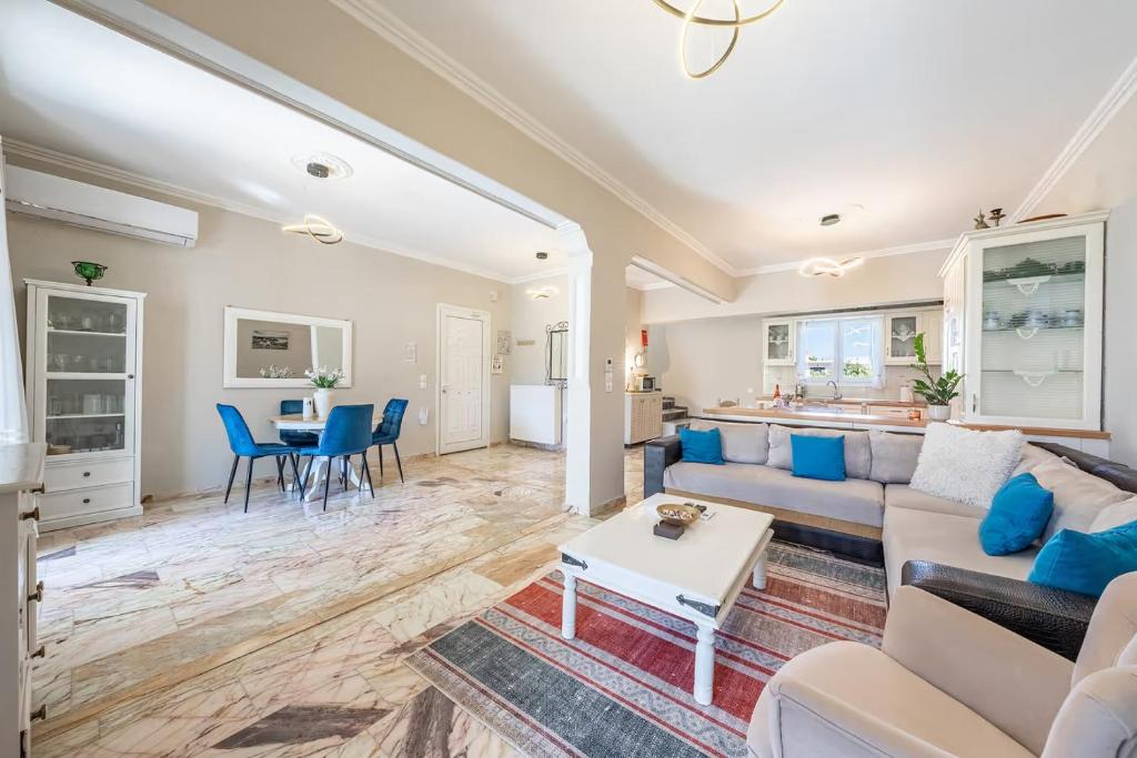 a living room with a couch and a table at Donna's luxury home in Kassiopi 300m from the sea in Kassiopi