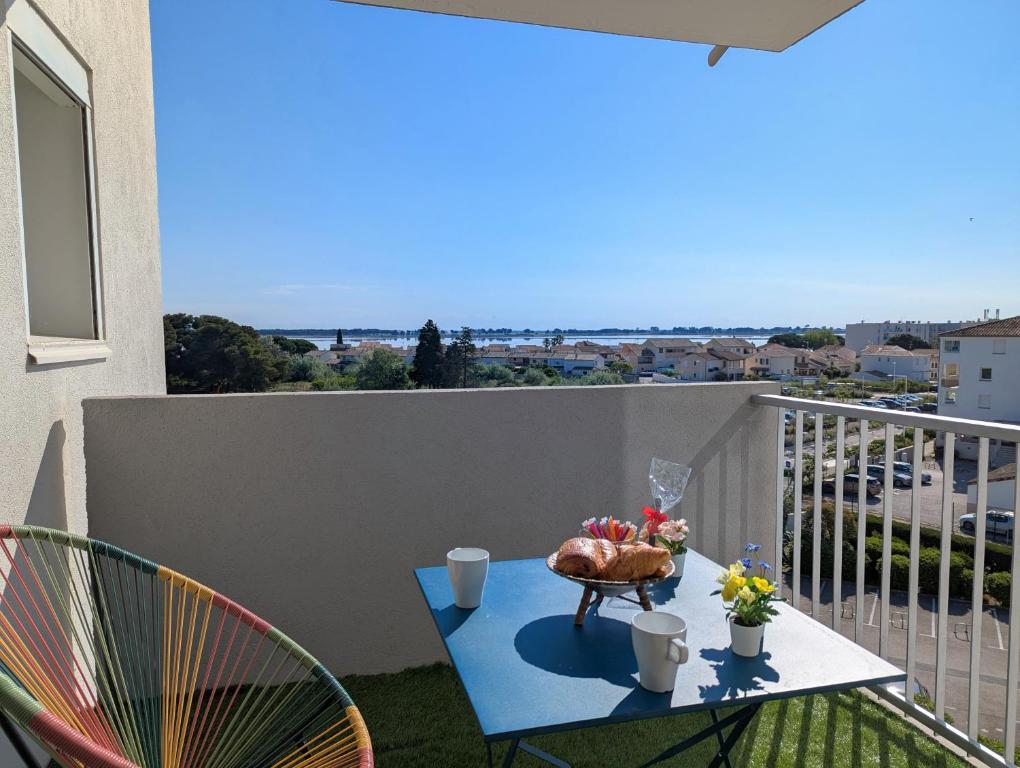 un balcon avec une table avec une dinde dessus dans l'établissement Sol-y-Days Sloop Port Royal 2 chambres et parking terrasse avec vue, au Grau-du-Roi