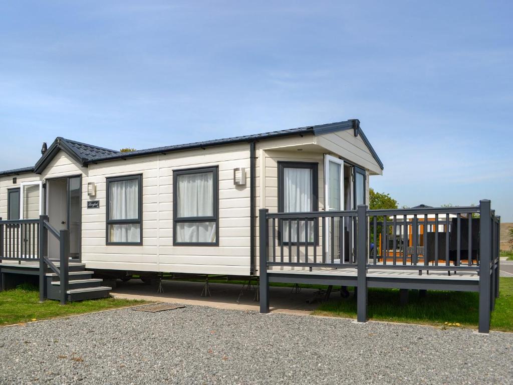 a white caravan with a porch and a deck at Lodge 46 - Uk49669 in Bridlington