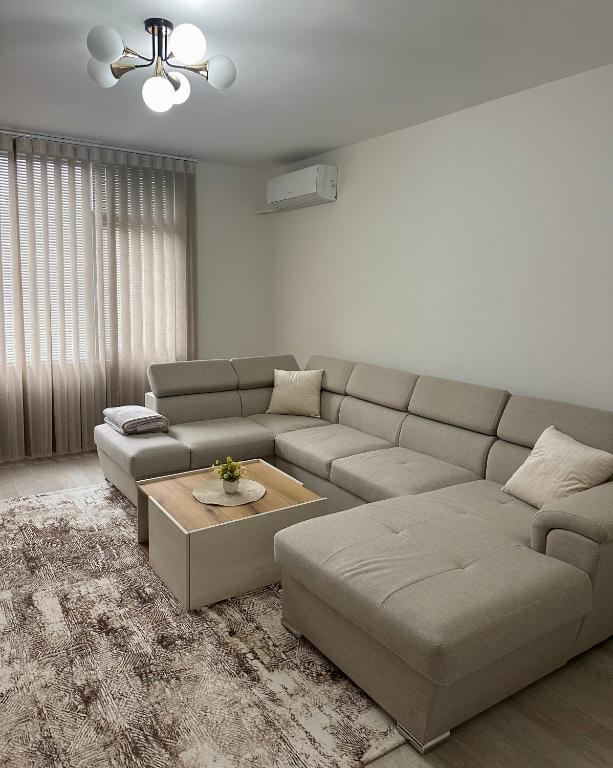 a living room with a couch and a table at Cozy Home 2 Bedroom apartment in Kyustendil