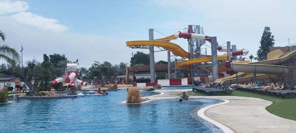 a water park with a water slide and slides at Camping LES DUNES Mobil home 6 personnes in Torreilles