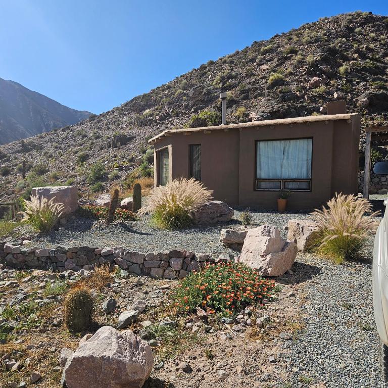 a house in the middle of a mountain at Cabañas Bodega Kindgard in Purmamarca