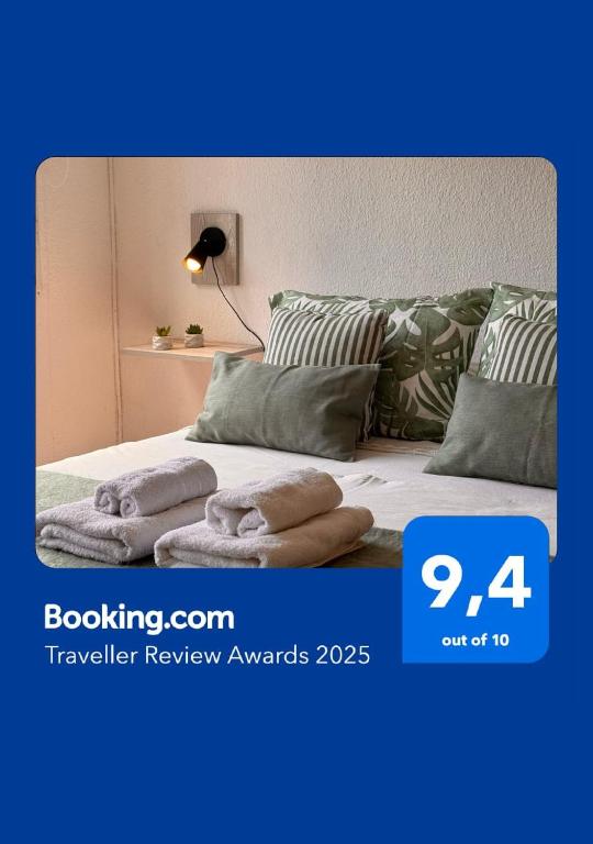 a bed with pillows on it with a blue at Ubicación Vista Cochera Wifi full in Mendoza