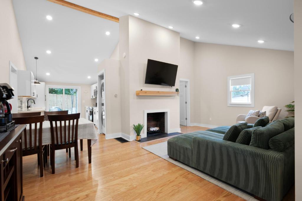 a kitchen and a living room with a couch and a fireplace at Buckeye Lake Cottage in Buckeye Lake