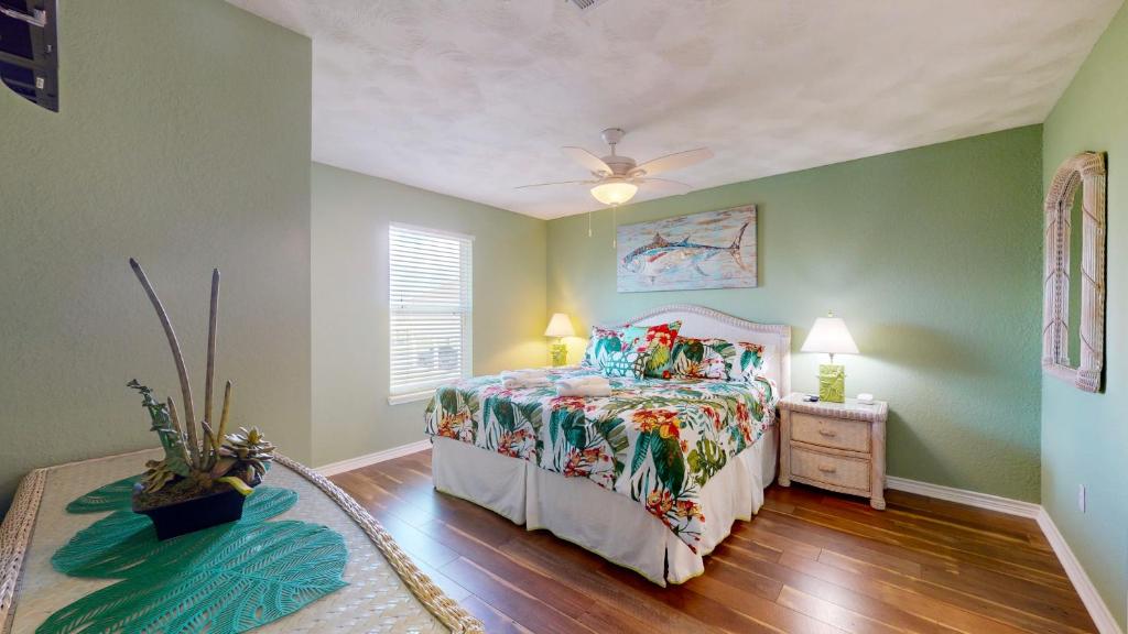 a bedroom with a bed and a ceiling fan at Casa Bella by Bolivar Escapes in Crystal Beach