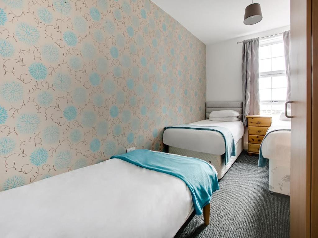 Postel nebo postele na pokoji v ubytování OYO Gin House Hotel
