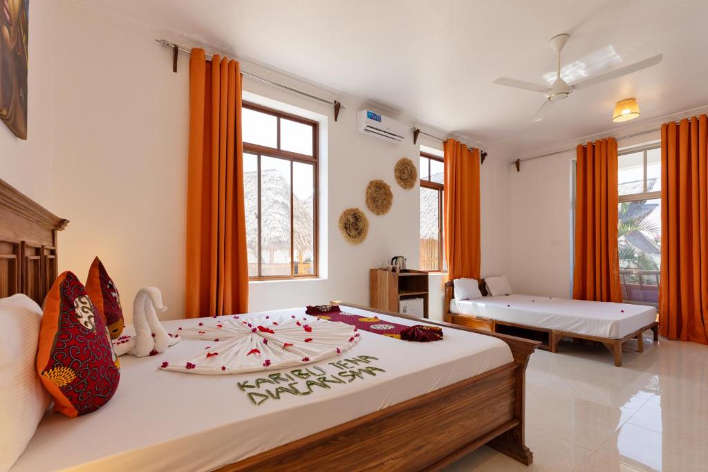 Postel nebo postele na pokoji v ubytování Diacarisma Boutique Resort Nungwi