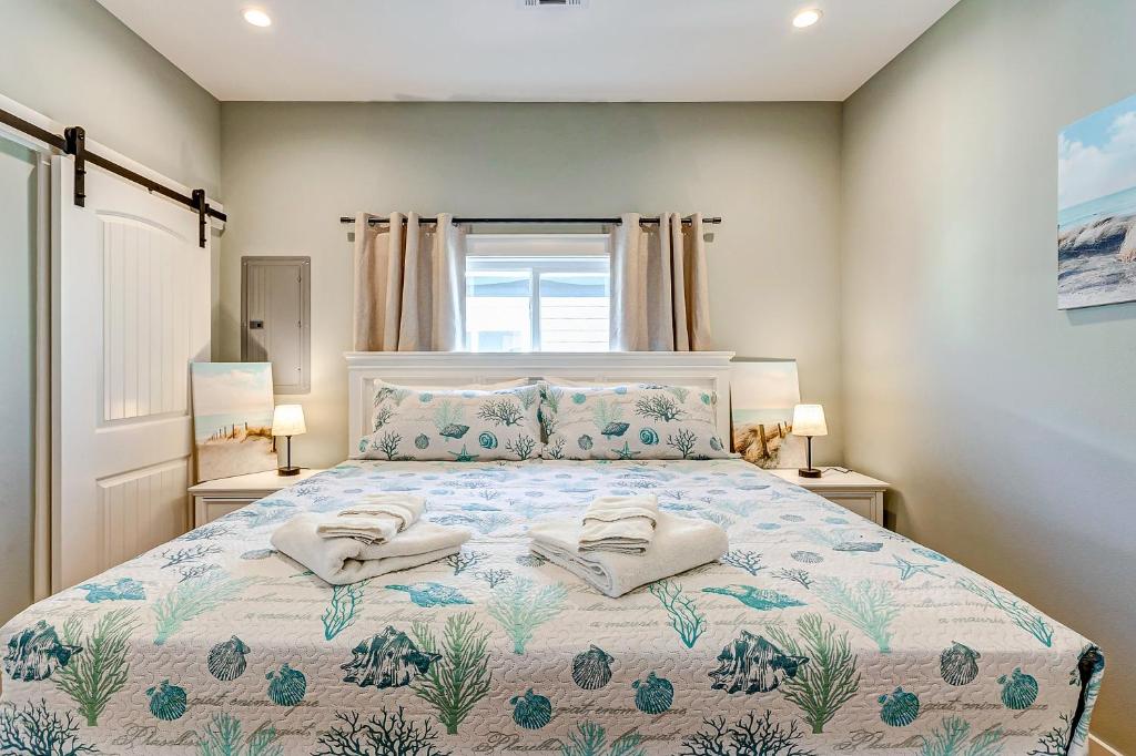 a bedroom with a bed with two towels on it at Sea You Soon in Port Bolivar
