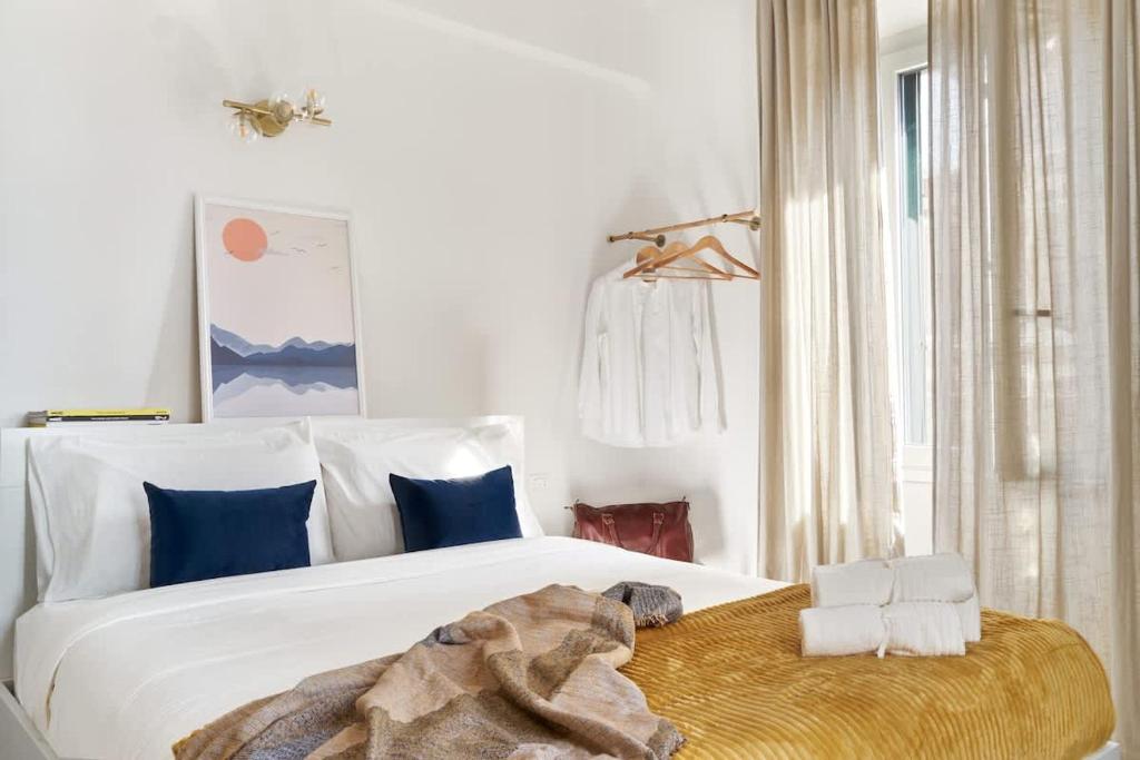 a bedroom with a large white bed with blue pillows at La Maison Blue, between Portello-Fiera-MiCo-CityLife in Milan