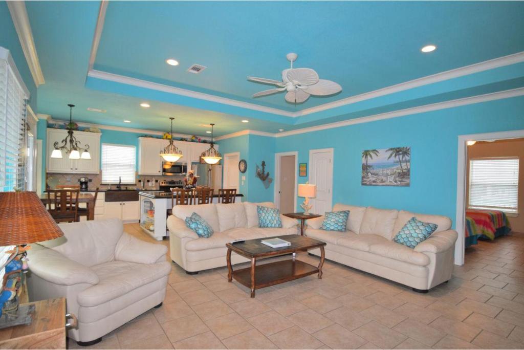 a living room with two white couches and a table at Sum Beach in Crystal Beach