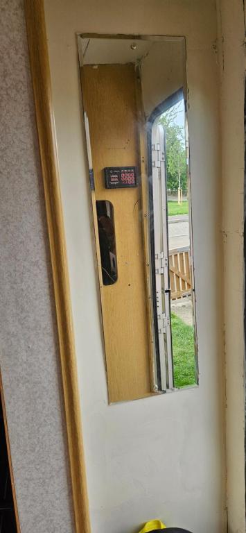 a mirror on the side of a door with a window at Caravan in Leicester