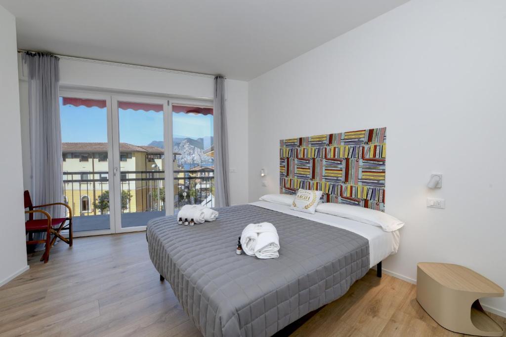 a bedroom with a bed with two animals on it at MGH - Malcesine Supreme Stay in Malcesine