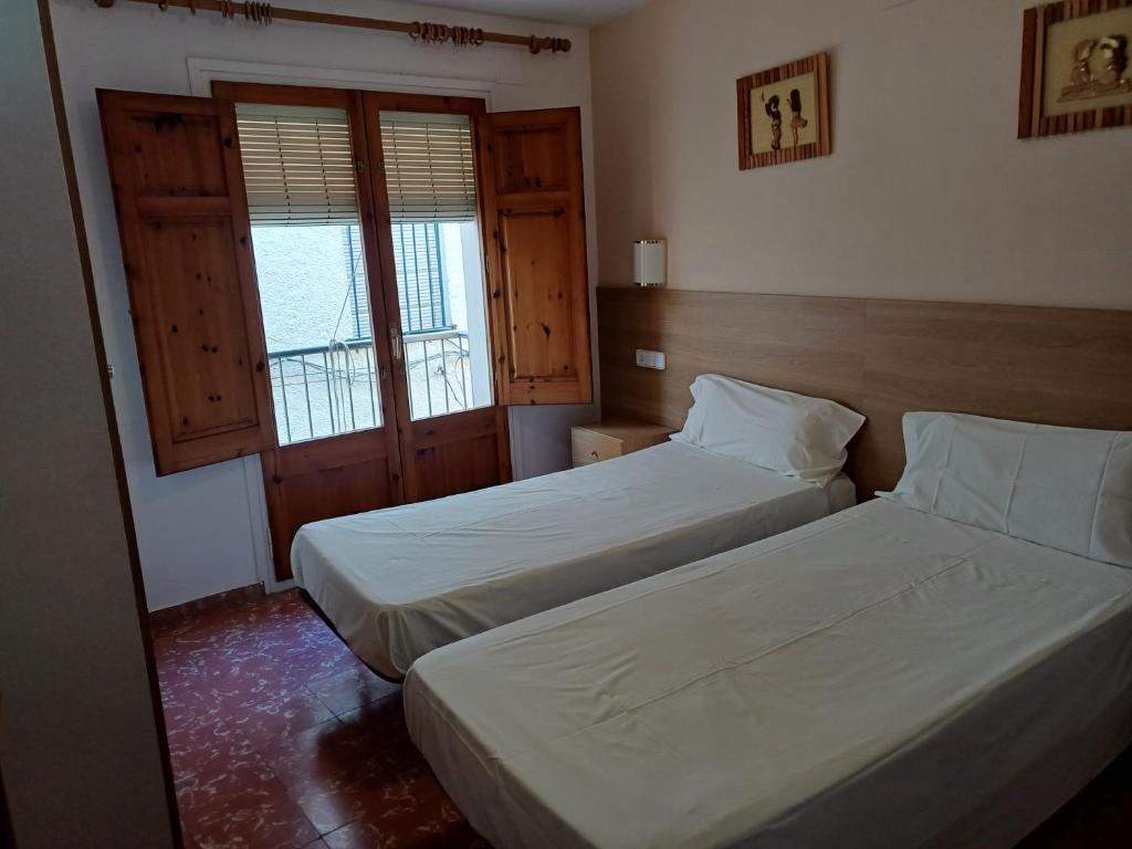 Postel nebo postele na pokoji v ubytování Hostal Sol i Sombra