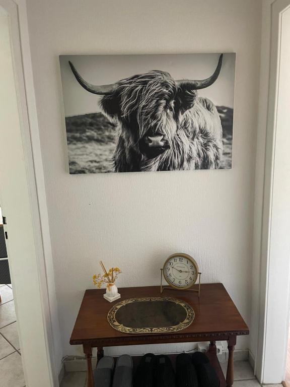 a picture of a bull on a wall with a clock at MAD Ferienwohnungen 1 in Dortmund