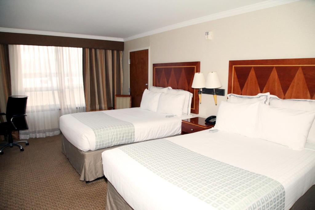 Postel nebo postele na pokoji v ubytování Hotel Executive Suites